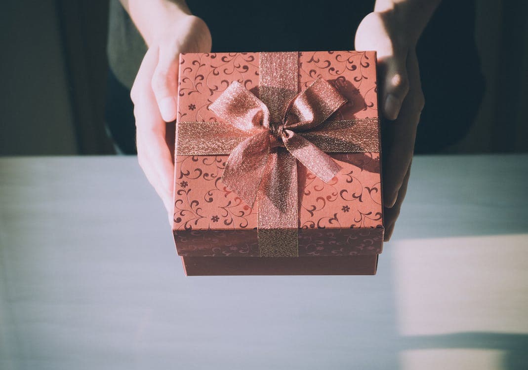 A person holding a gift box