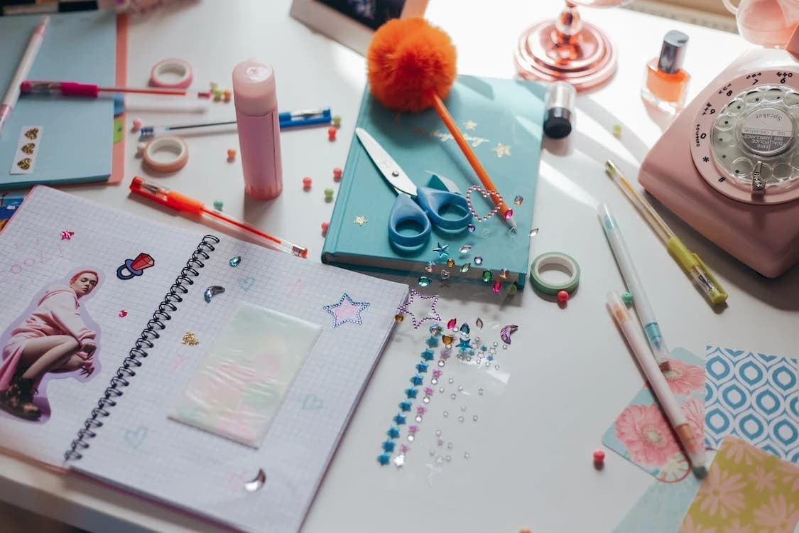 A table full of colored paper scattered around